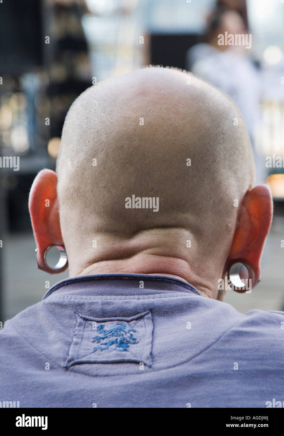 A bald man with large gauge earlobe piercings Stock Photo Alamy