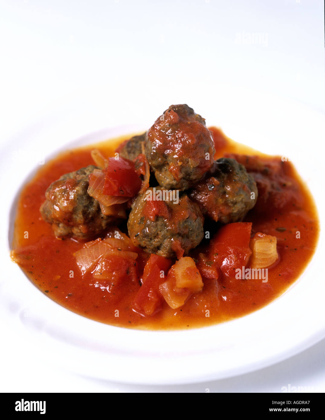 DISH OF ORGANIC SPICY MEATBALLS ON WHITE PLATE ON WHITE BACKGROUND Stock Photo