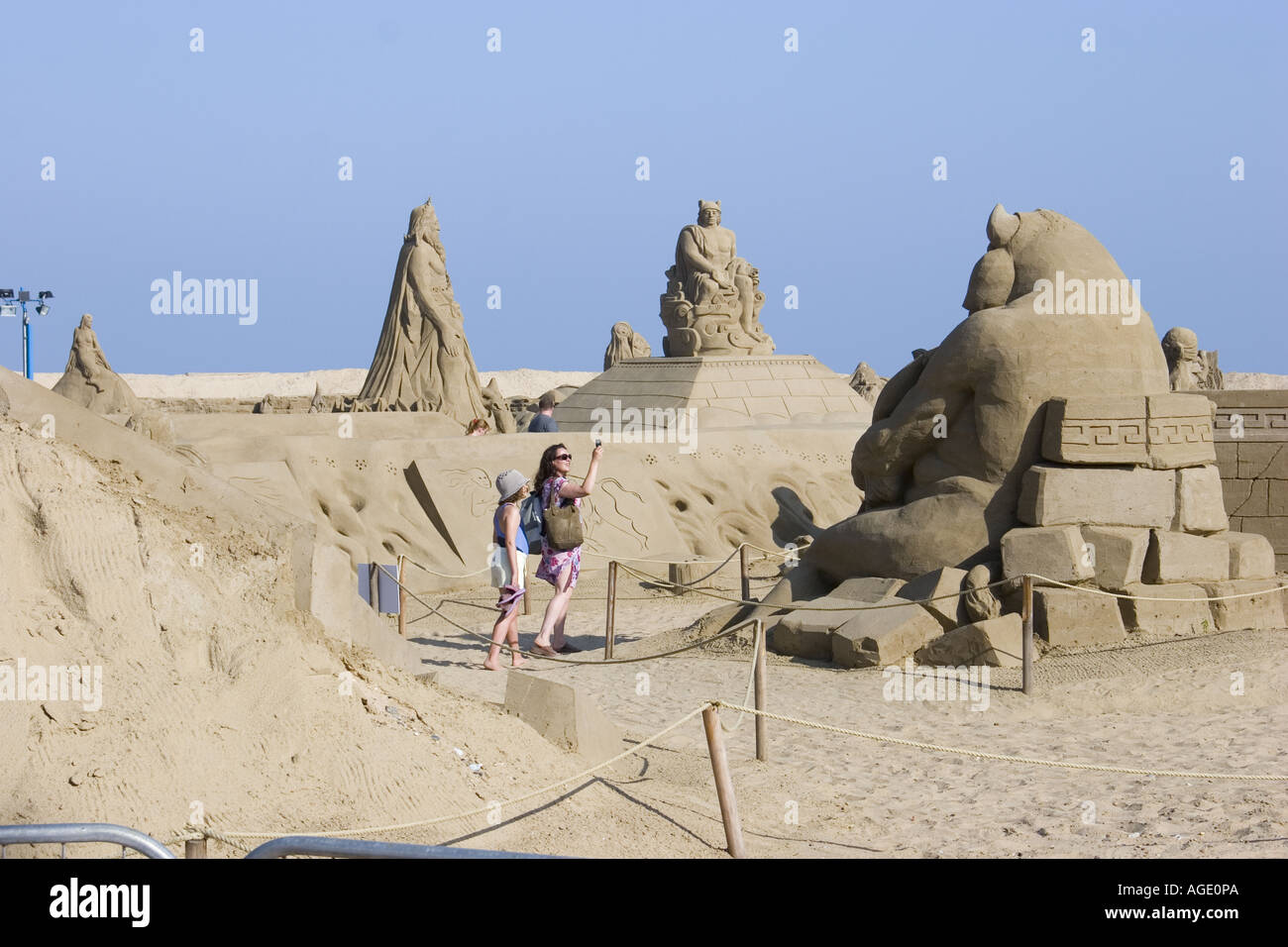 Two tourists marvel at a giant sand sculpture on Great Yarmouth Central ...