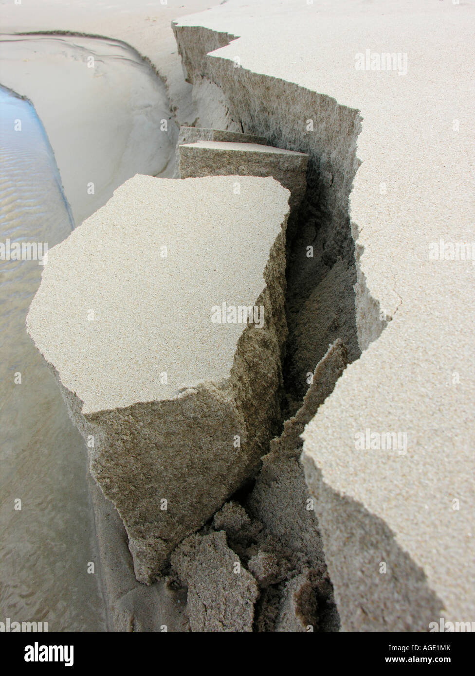 Eroded sandbank along river breaking off Stock Photo