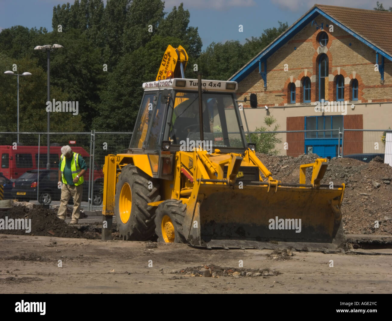 The road crew at work. A JCB and workman fixing a car park Stock Photo