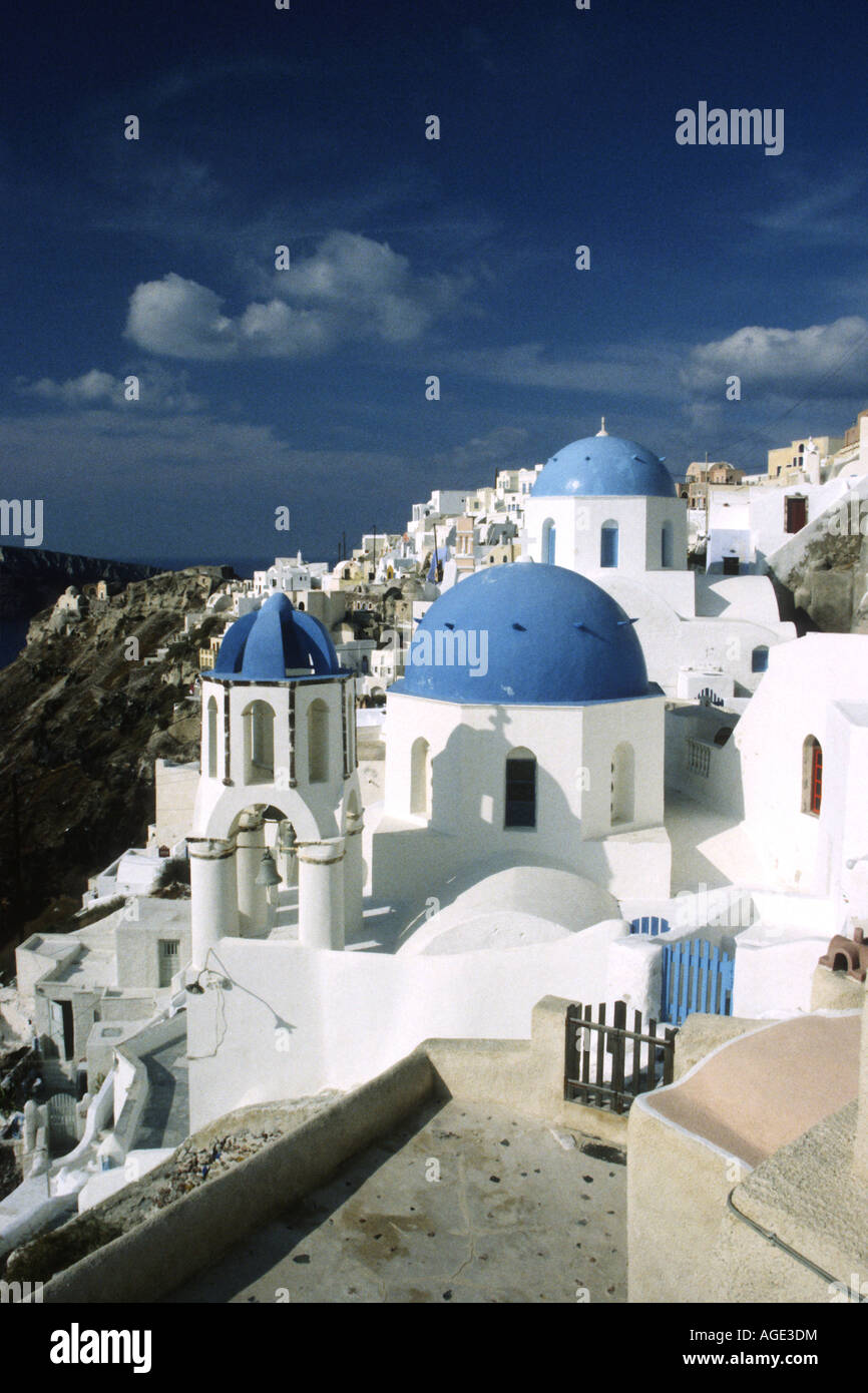 Blue domes are a speciality of many of the houses in Oia on Santorini Island . Stock Photo