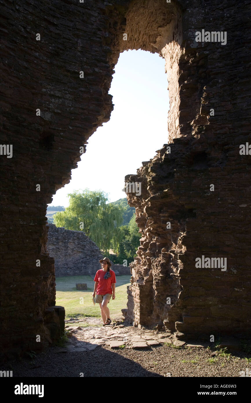 Female visitor carrying guidebook at the round keep Skenfrith Castle ...