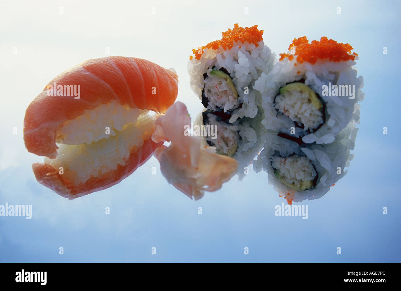 Sushi with wasabi and ginger on a mirror. Reflection of food and sky in ...