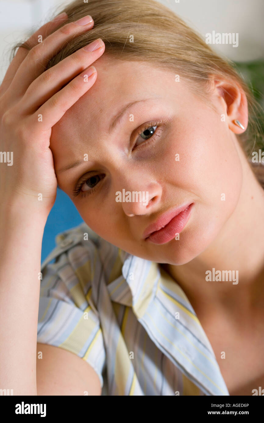 She looks depressed, anxious and in pain. Stock Photo