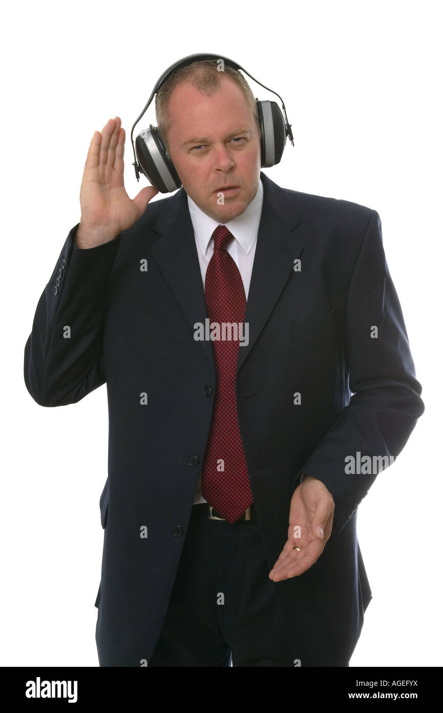 Businessman wearing earphone struggling to hear Communication concepts Stock Photo