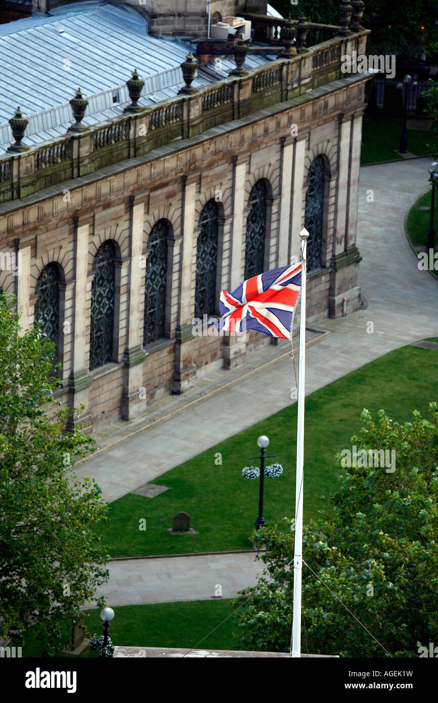 St Philips Cathedral in the centre of Birmingham UK Office buildings in the background UK flag Stock Photo