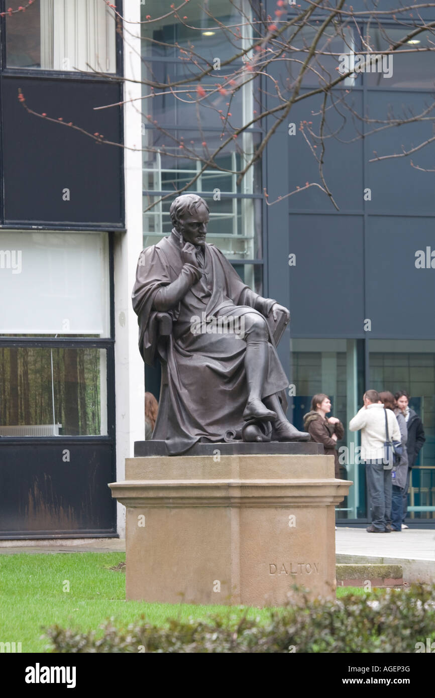 John Dalton statue outside Manchester Metropolitan University s John Dalton Building with students in background Stock Photo