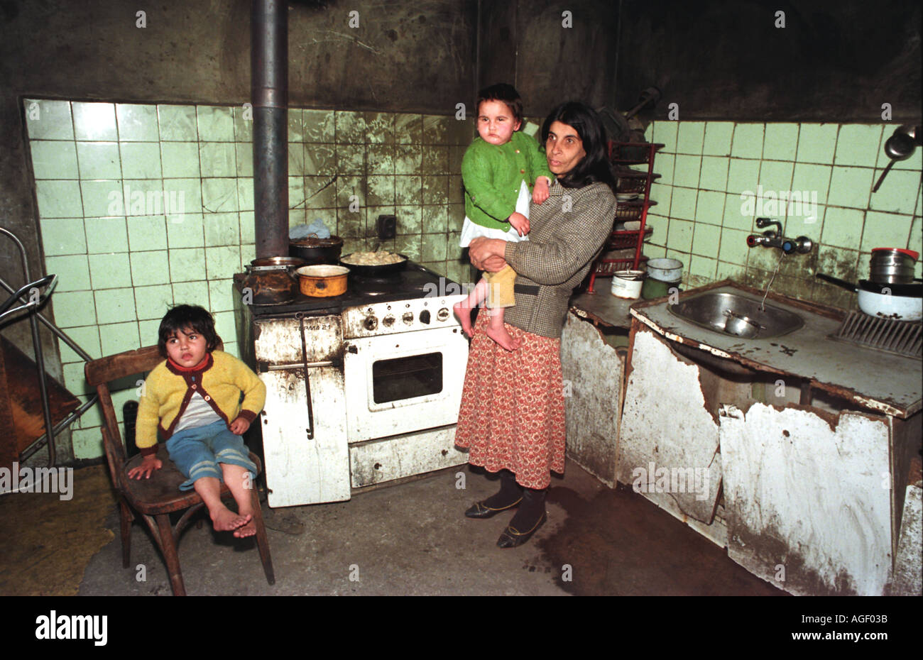 Gypsy mother and children in her kitchen Bulgaria Stock Photo