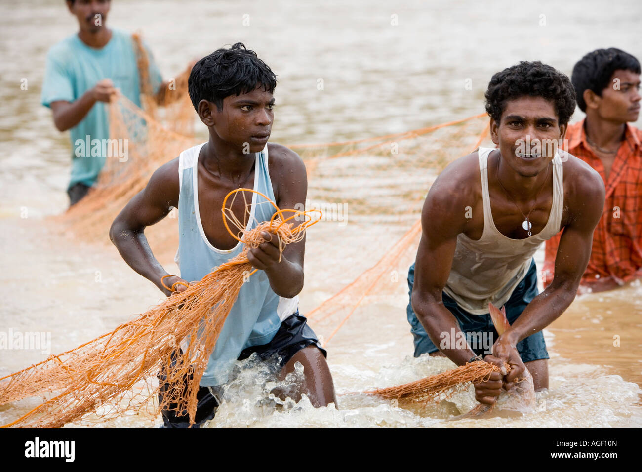 Young Indian men net fishing. Puttaparthi, Andhra pradesh, India Stock