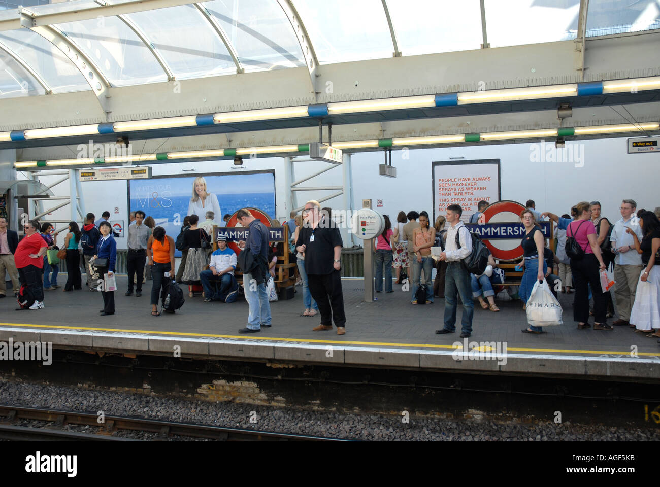 Hammersmith tube station platform with passengers London Stock Photo