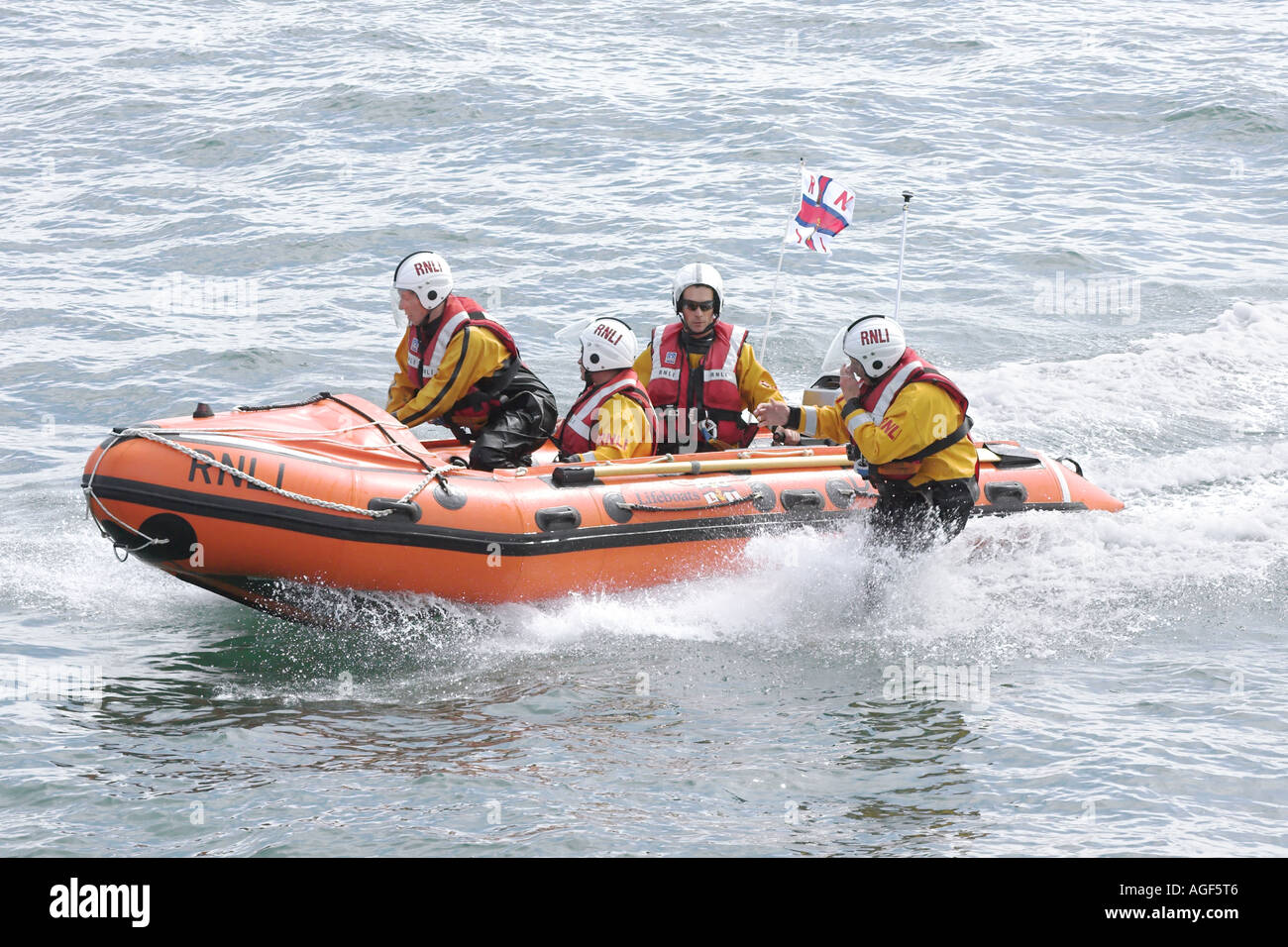 RNLI D series inshore lifeboat in action man overboard rescue drills Stock Photo