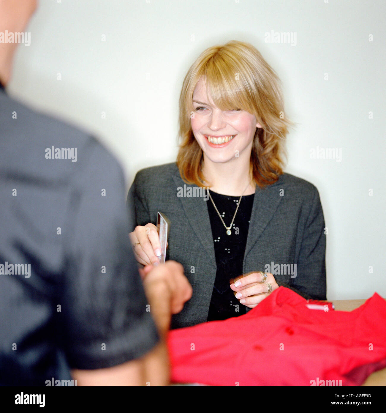 Man buying clothes with credit card Stock Photo Alamy