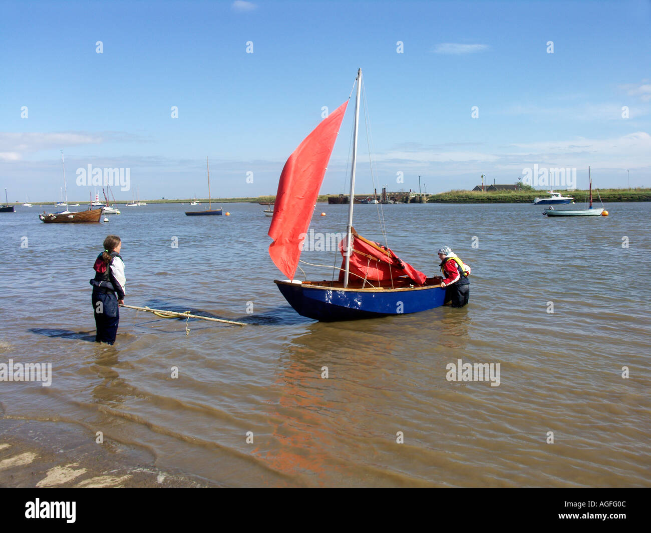 Mirror dinghy with red sail Orford sailing club Suffolk England Stock