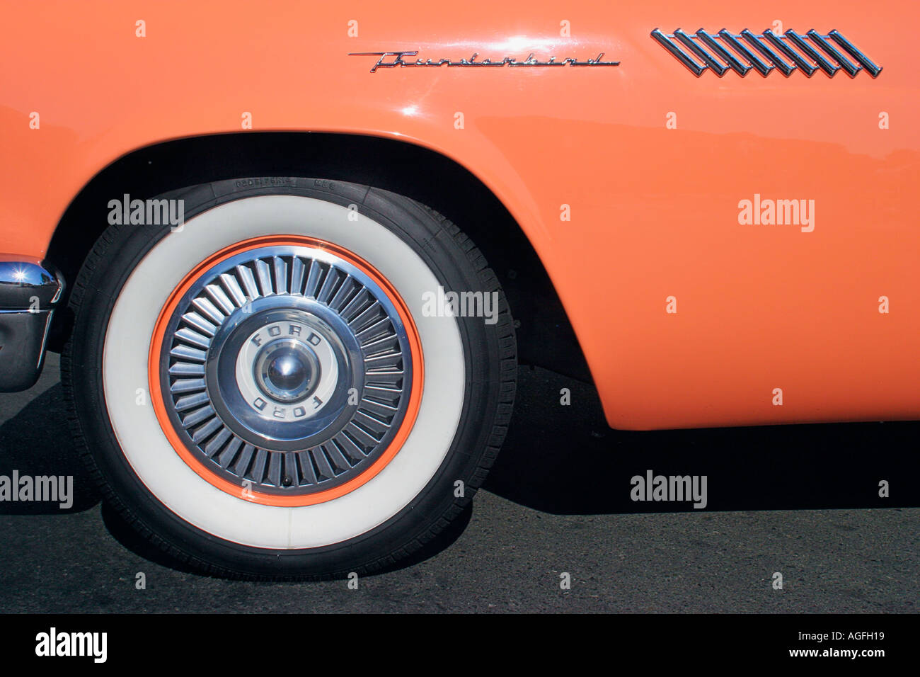Closeup detail of tire and emblem on 1955 Ford Thunderbird automobile at classic car show Stock Photo