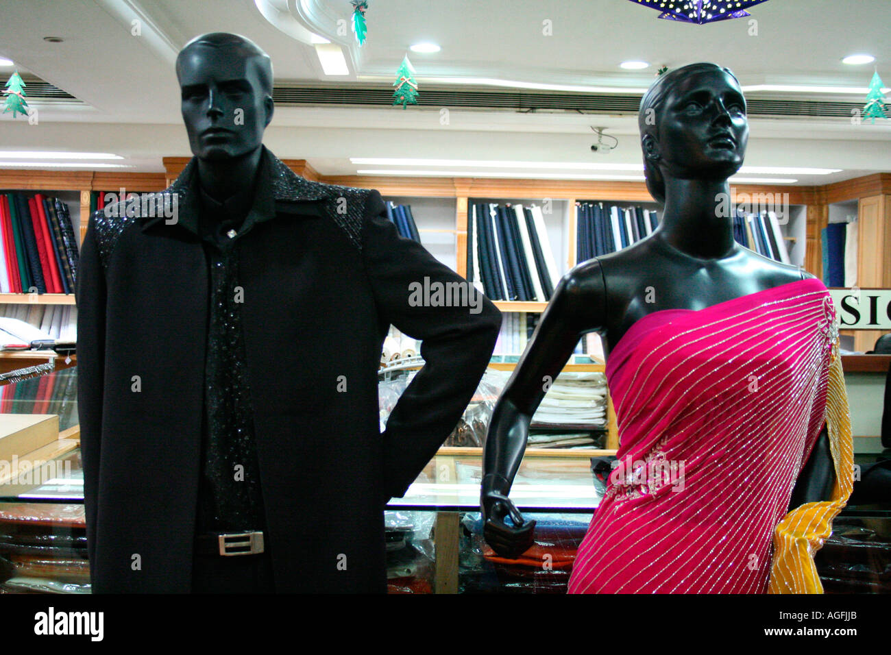Male and female mannequins dressed up in party wear in a shopping mall in Kerala, India Stock Photo