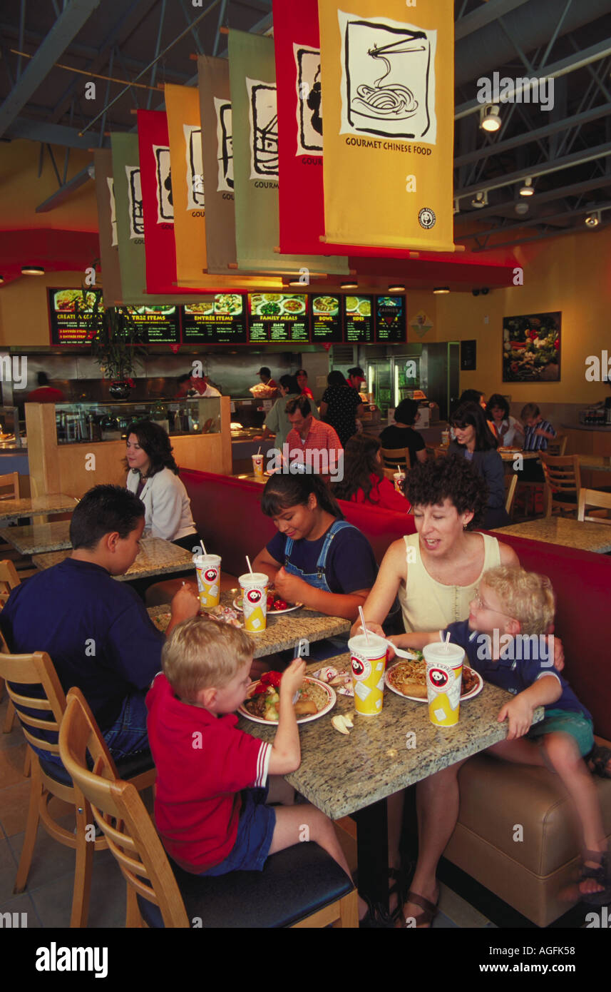 Customers in a fast food Chinese restaurant sitting at tables eating Stock Photo