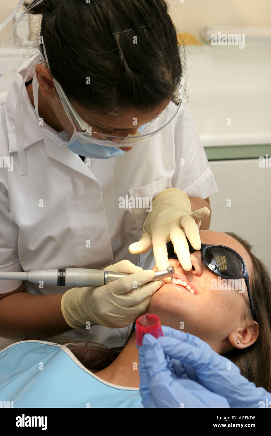 Dental Surgery Dentist nurse and patient being drilled Stock Photo