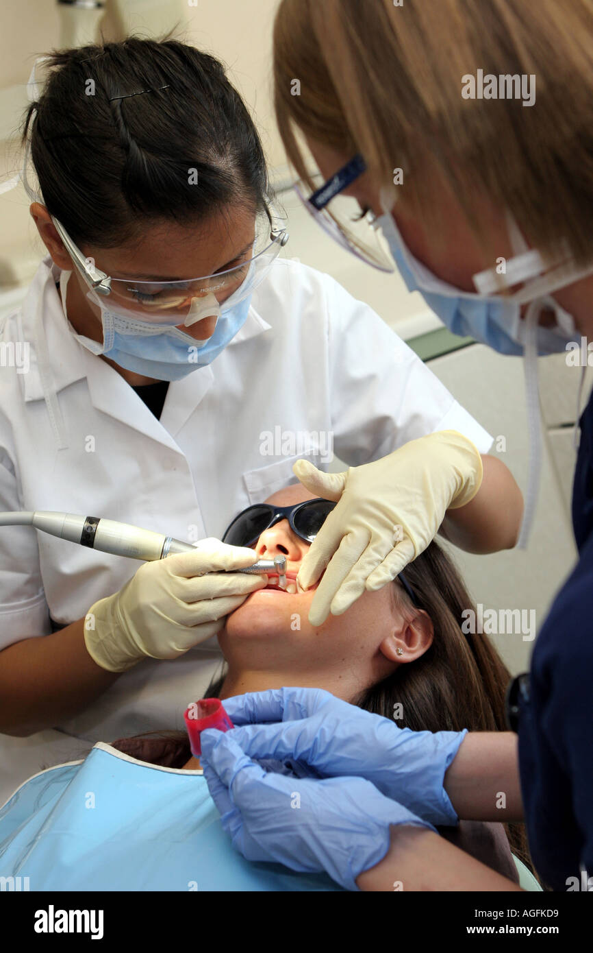 Dental Surgery Dentist nurse and patient being drilled Stock Photo
