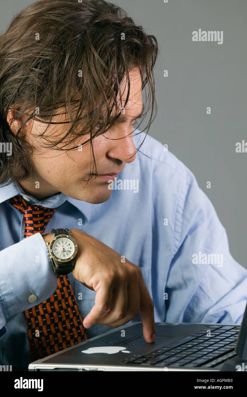 Young Latino businessman working on laptop computer Stock Photo