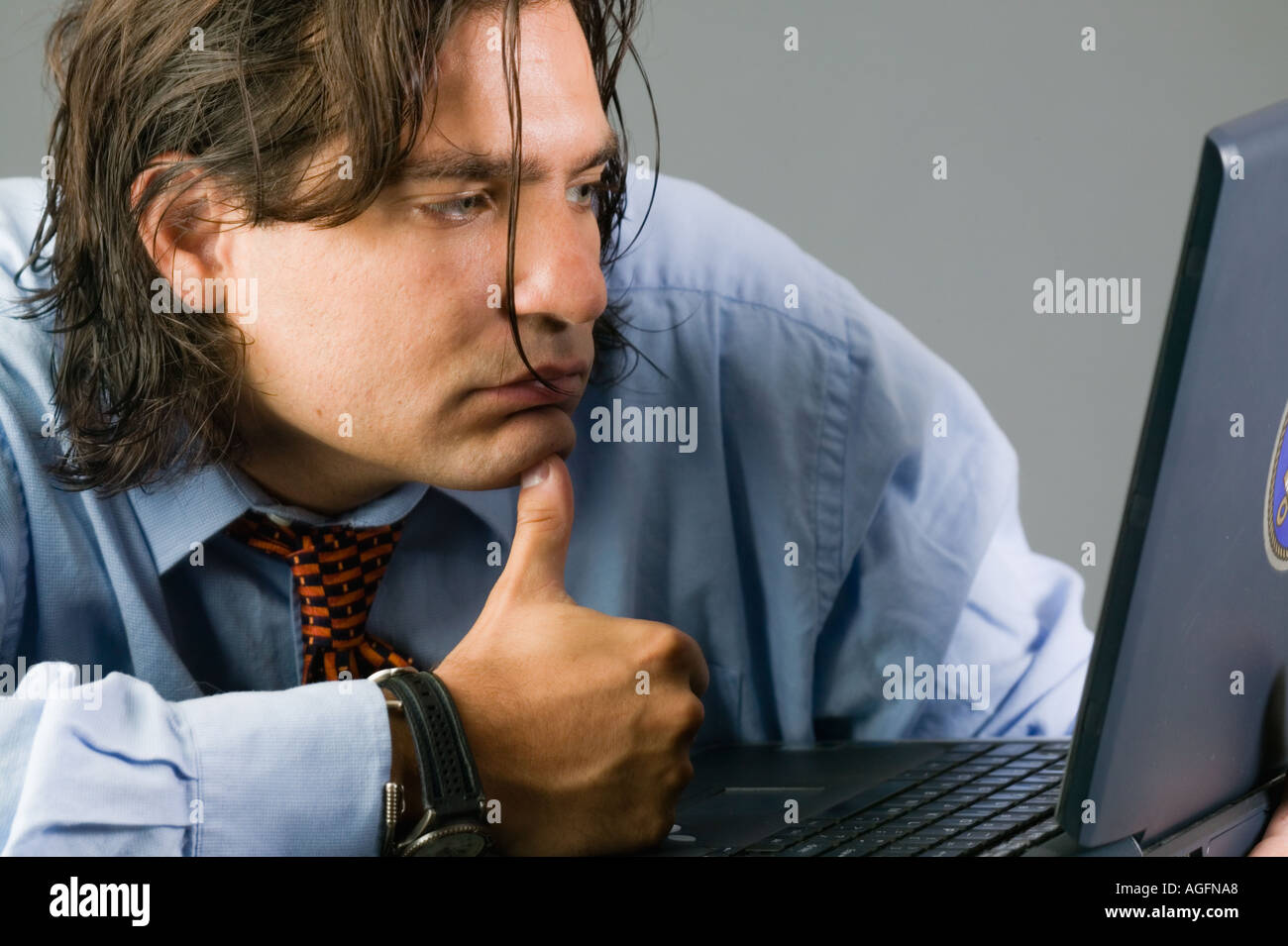 Young Latino businessman working on laptop computer Stock Photo