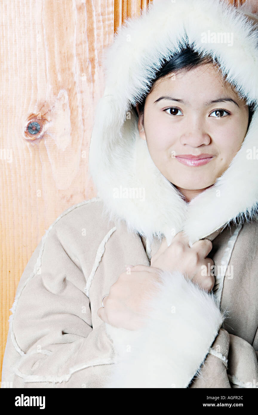 Young Woman Holding Coat Hood for Warmth Stock Photo