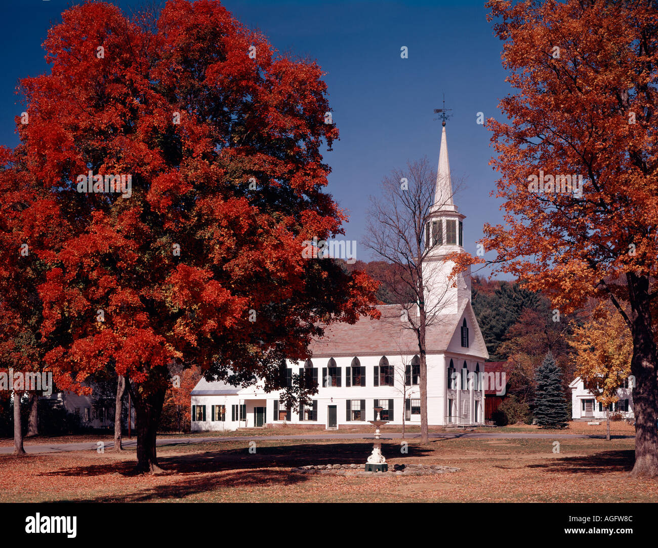 Townshend in Vermont autumnal scene with brilliant red maple leaves and the village church Stock Photo