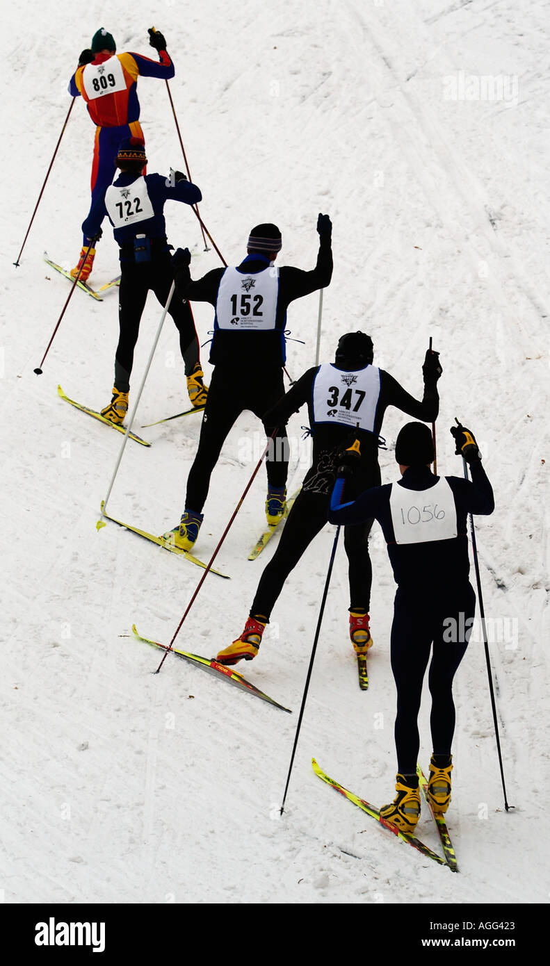 A line of skiers make their way up a hill during the City of Lakes ...