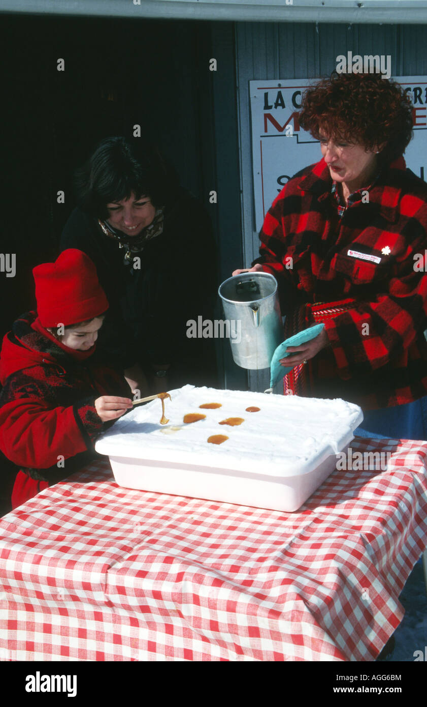Child tasting maple sugar at a 'sugar shack' in the Rosemont Hills near