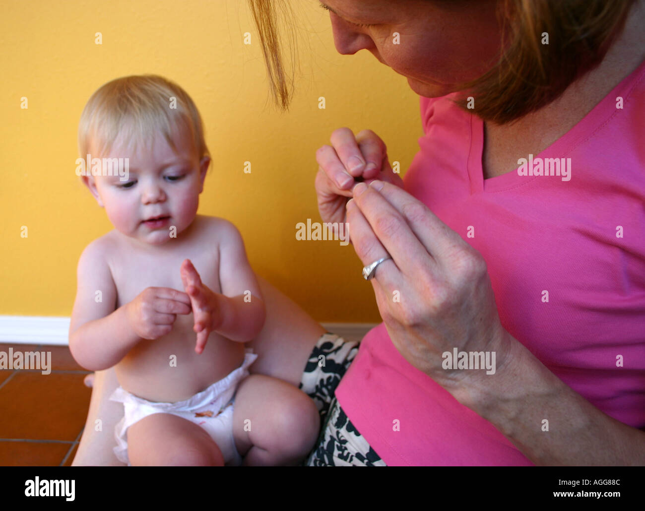 mother communicating with child using sign language Stock Photo