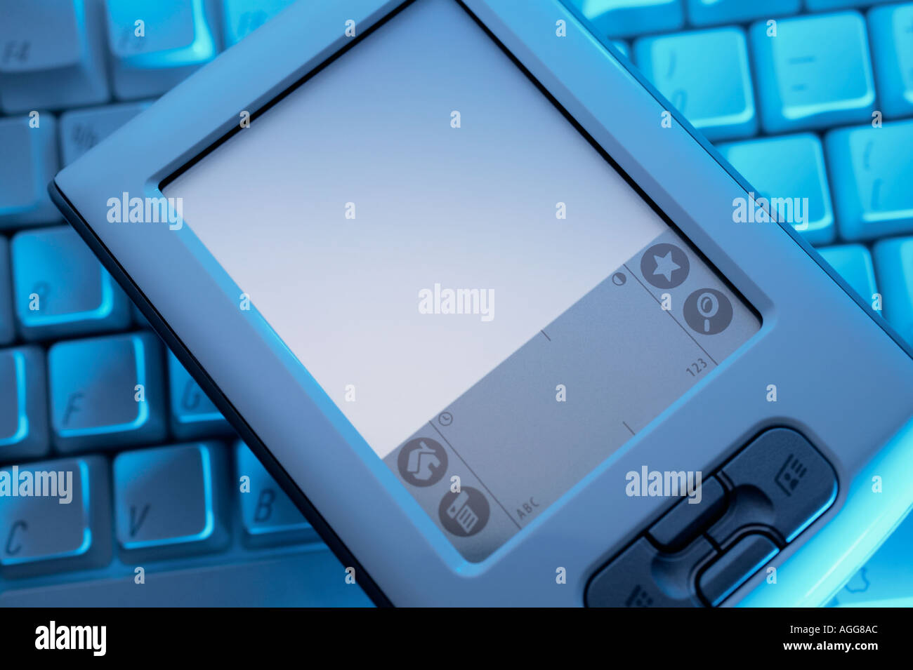 Handheld computer on keyboard Stock Photo Alamy