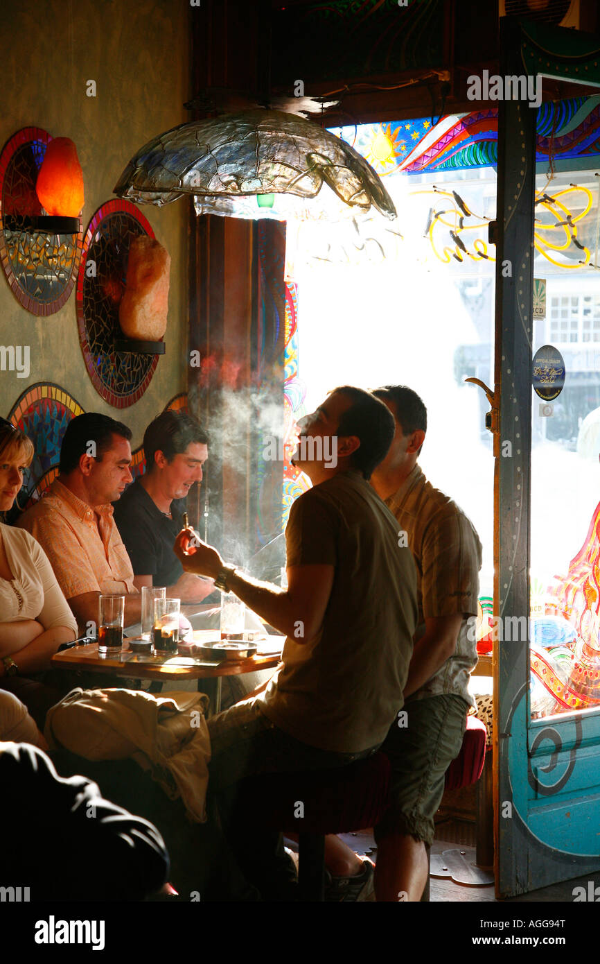 People sitting inside a Coffee shop smoking joints Amsterdam Holland Stock Photo