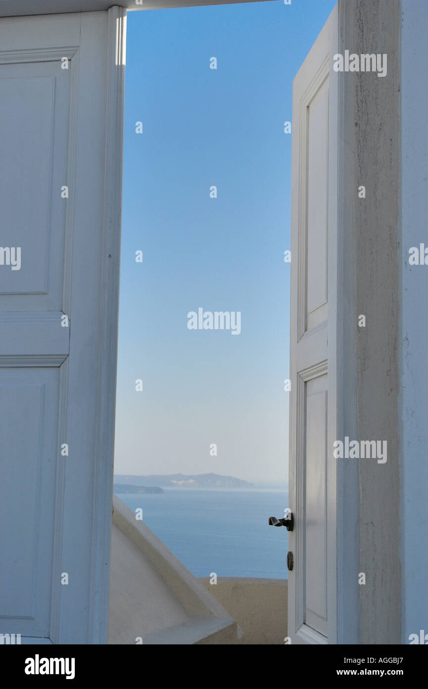 slightly opened door with blue sky behind, village of Oia, Santorini island, Greece Stock Photo