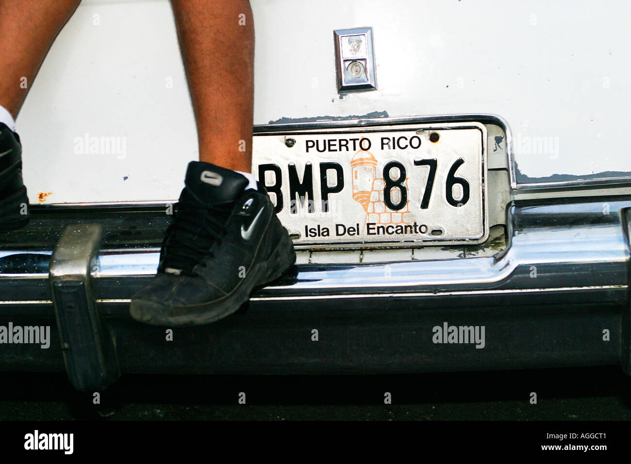 Kids legs next to car number plate in Villa Kennedy in San Juan Puerto Rico Stock Photo