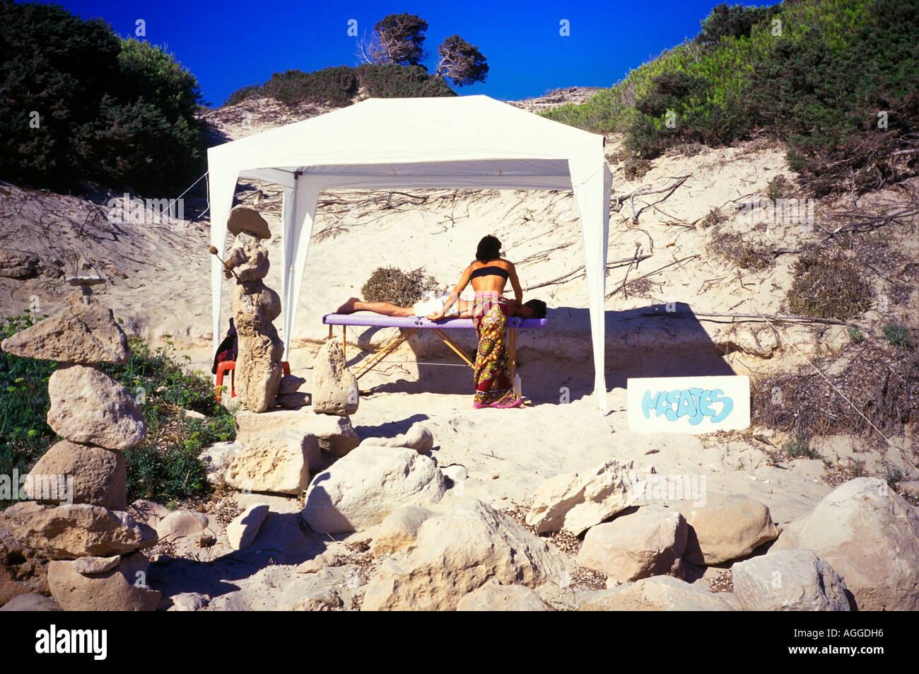 Massage on Sa Trinchas Beach Ibiza Stock Photo