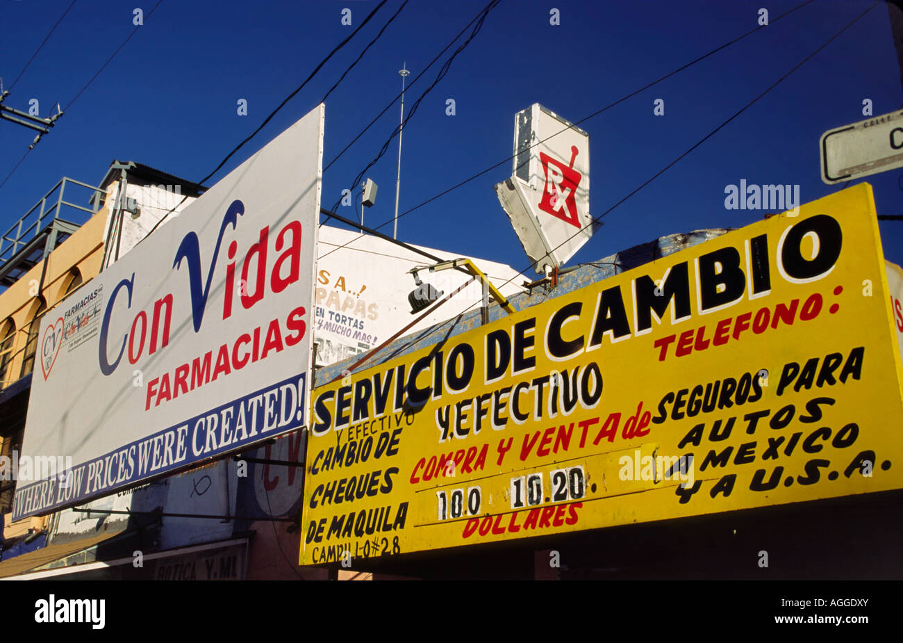 Pharmacy and money exchange shop signs in Nogales, Mexico Stock Photo