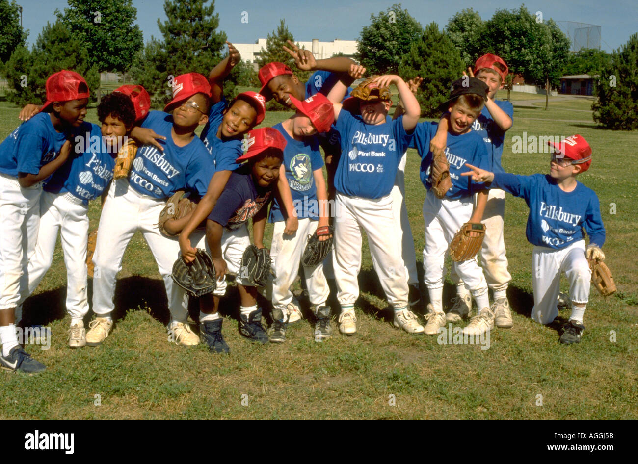 Interracial 12 year old inner city baseball team goofing off during practice. St Paul Minnesota USA Stock Photo