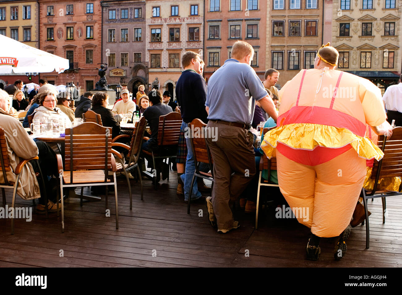 Guy in an inflatable outfit enjoying a Stag weekend in the Old Market Square Warsaw Stock Photo