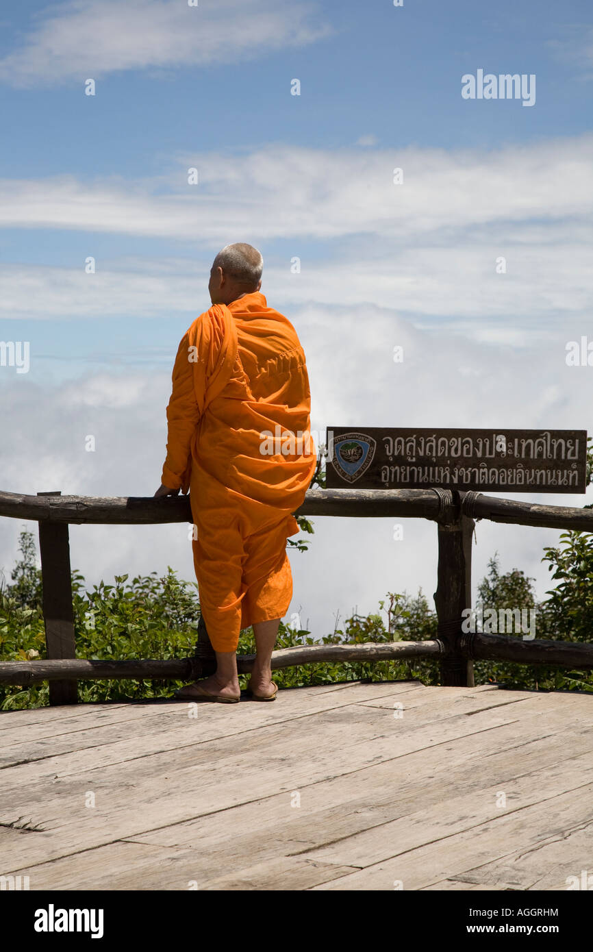Buddhist monk in saffron robes at the summit of Doi Inthanon the