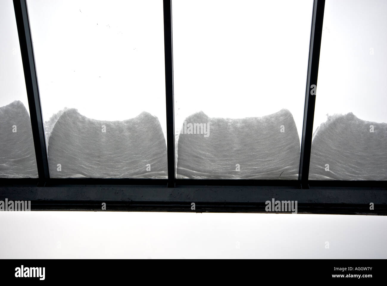 GLASS ROOF WINDOW SKY LIGHT UNDER BLANKET OF SNOW Stock Photo