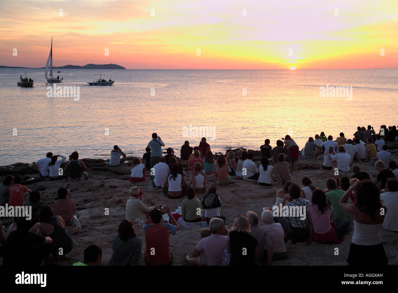 Tourists at Cafe del Mar, watching the sunset, Ibiza, Spain Stock Photo