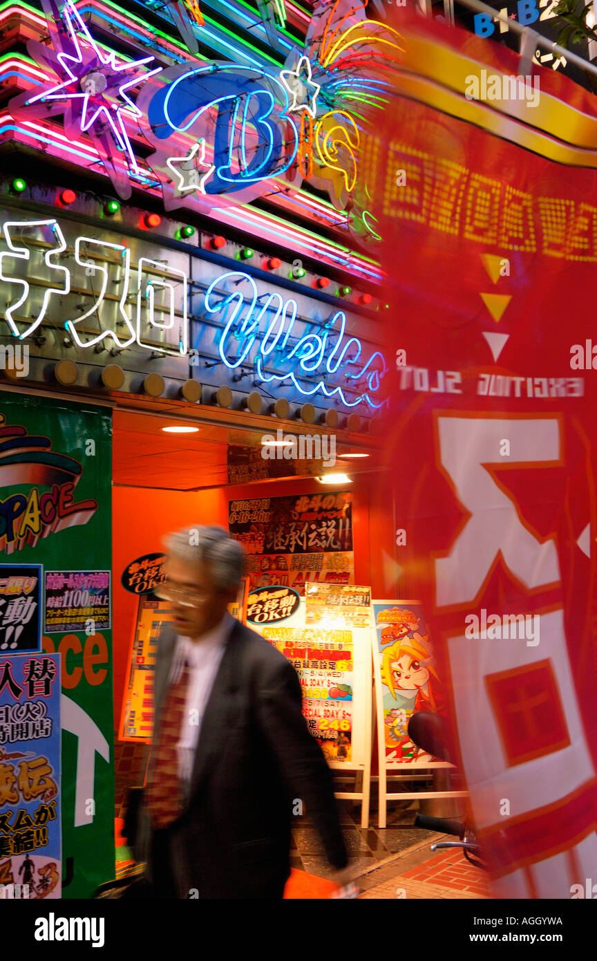 businessman passing amusement arcade, Shinjuku, Tokyo, Japan Stock Photo