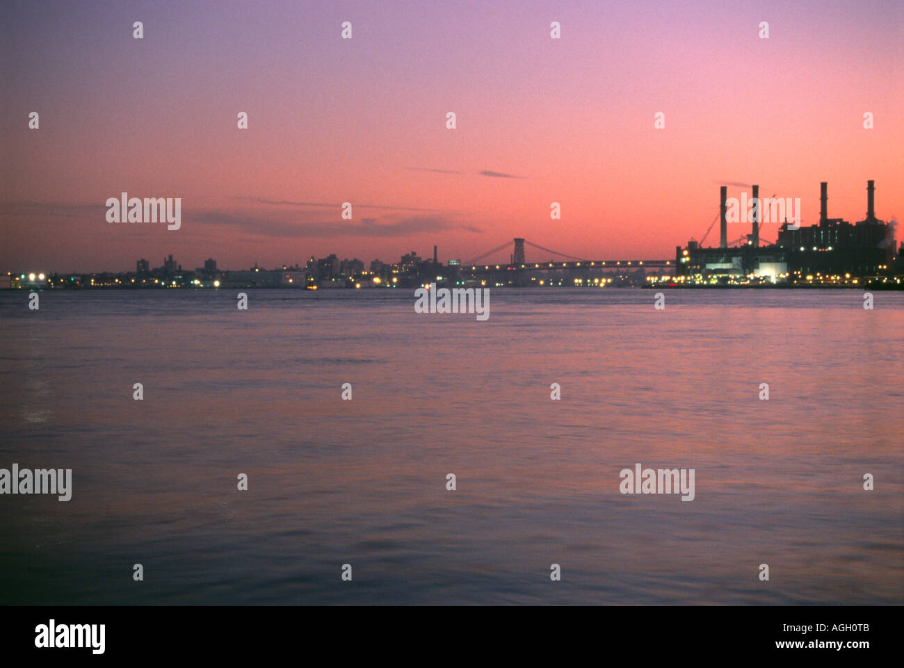 A view of the East river in New York City with the Con edison plant at East 14th Street at sunset. Stock Photo