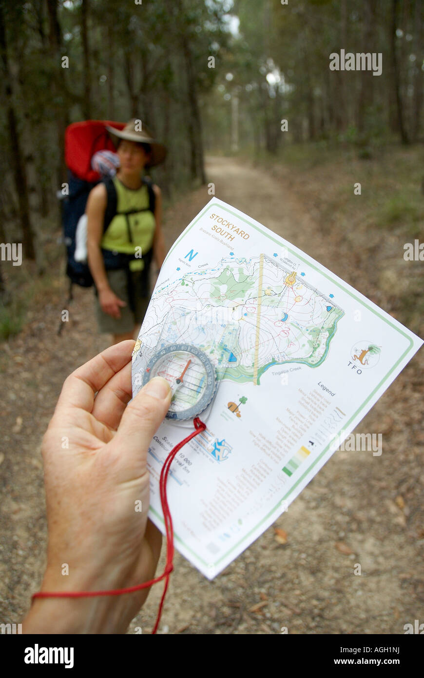 Family using a map and compass during an orienteering course Stock ...