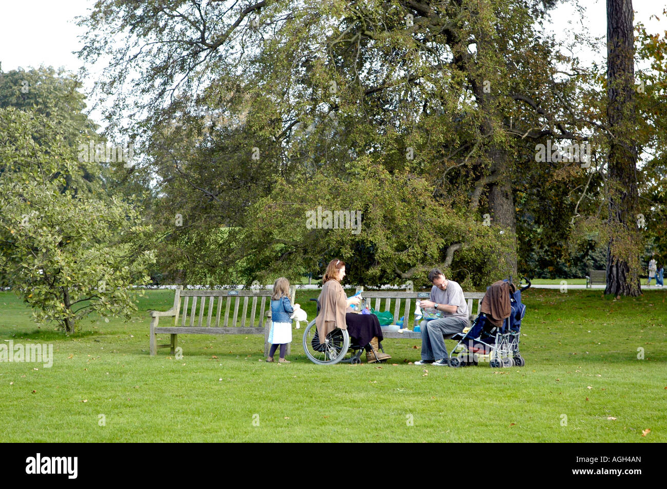Disabled mother having pic nic with her family on Sunday at Kew Gardens, London Stock Photo