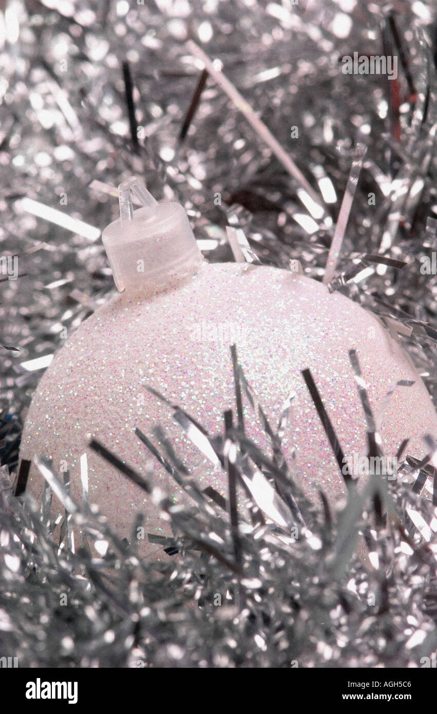 Single christmas bauble surrounded by silver tinsel Stock Photo