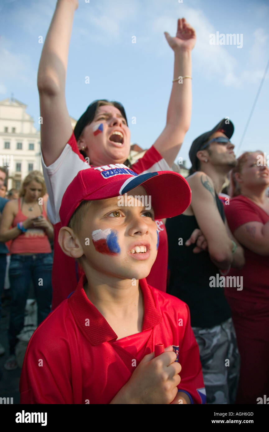 Young Czech boy and his Mom watch their National soccer team play  on a big screen in the town Square, Prague, Czech Republic Stock Photo