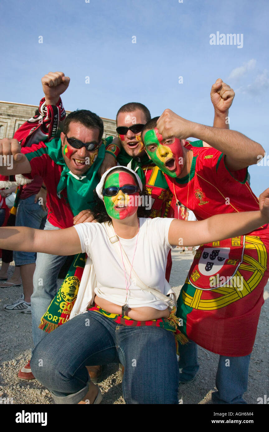 Group of young Portugese soccer (football) fans cheer during a  fan  fest celebration in Germany during the 2006 World Cup Stock Photo