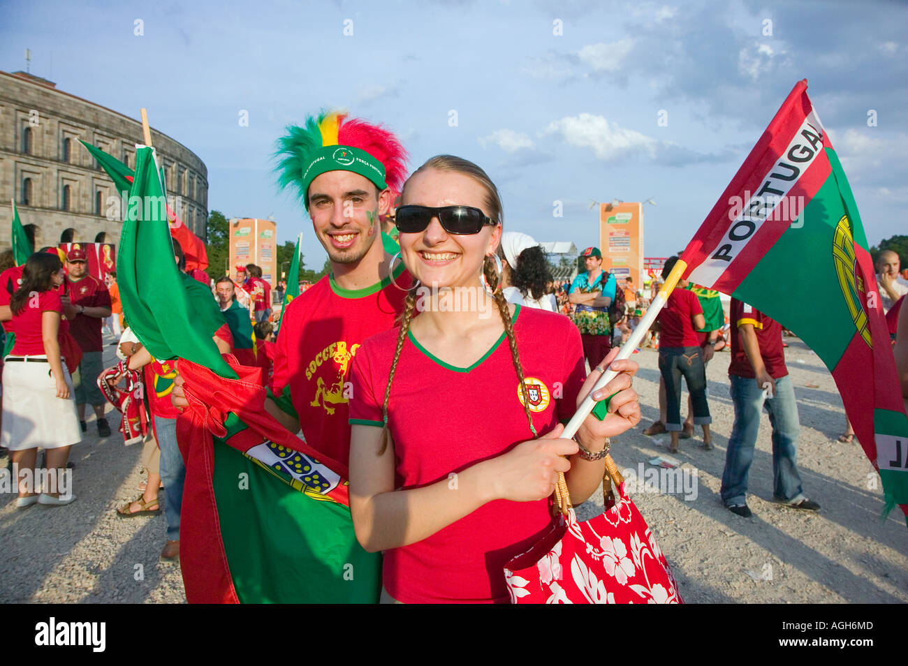 Two young Portugese soccer (football) fans   wave flags at a fan fest in Germany during  2006 World Cup Stock Photo