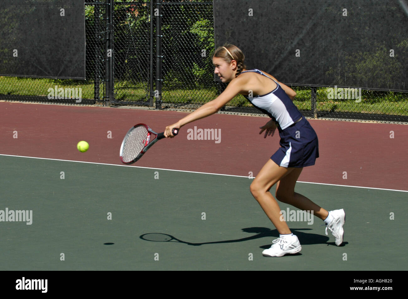 Female high school tennis action Stock Photo